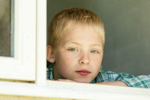 Autism Diary - Week 3. Images shows boy looking out of the window