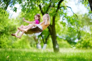 Fun activities on a budget. Images shows children playing on swing