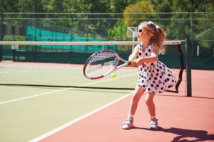 Fun activities on a budget. Image shows child playing tennis