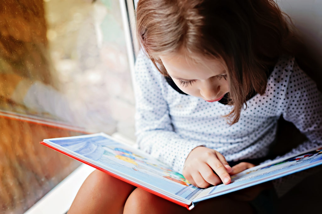 Ways to encourage children to learn: images shows a child reading